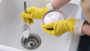 putting baking soda into drain