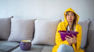 woman stressed because of leaks in her ceiling