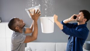 2 guys catching huge leak from the ceiling