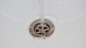 faucet running through a sink drain