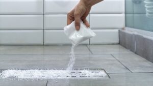 dumping baking soda into drain