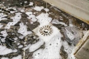 shower draining soapy water